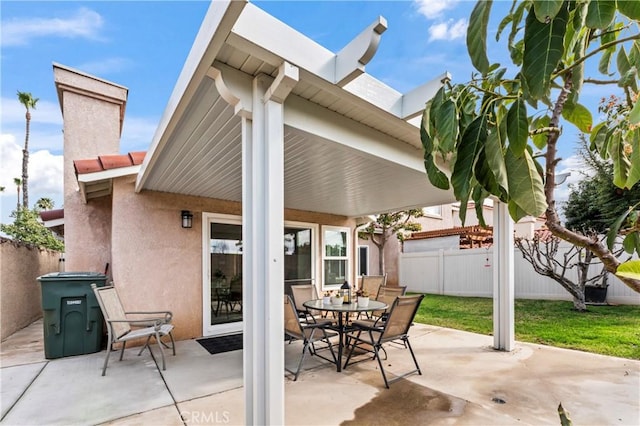 view of patio / terrace featuring outdoor dining space and fence