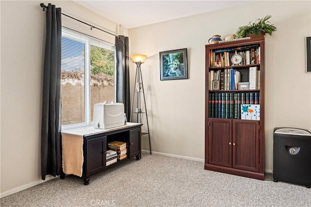 interior space featuring light colored carpet and baseboards