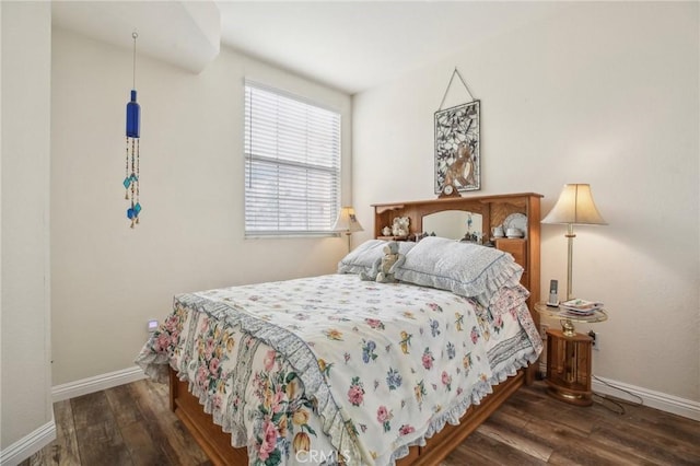 bedroom with baseboards and wood finished floors