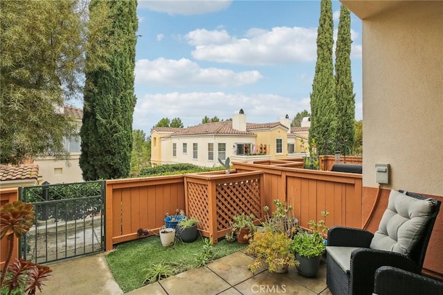 view of patio with a balcony and fence