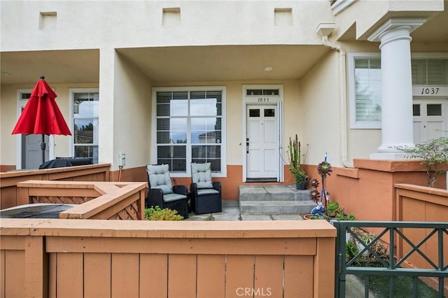 view of exterior entry with stucco siding