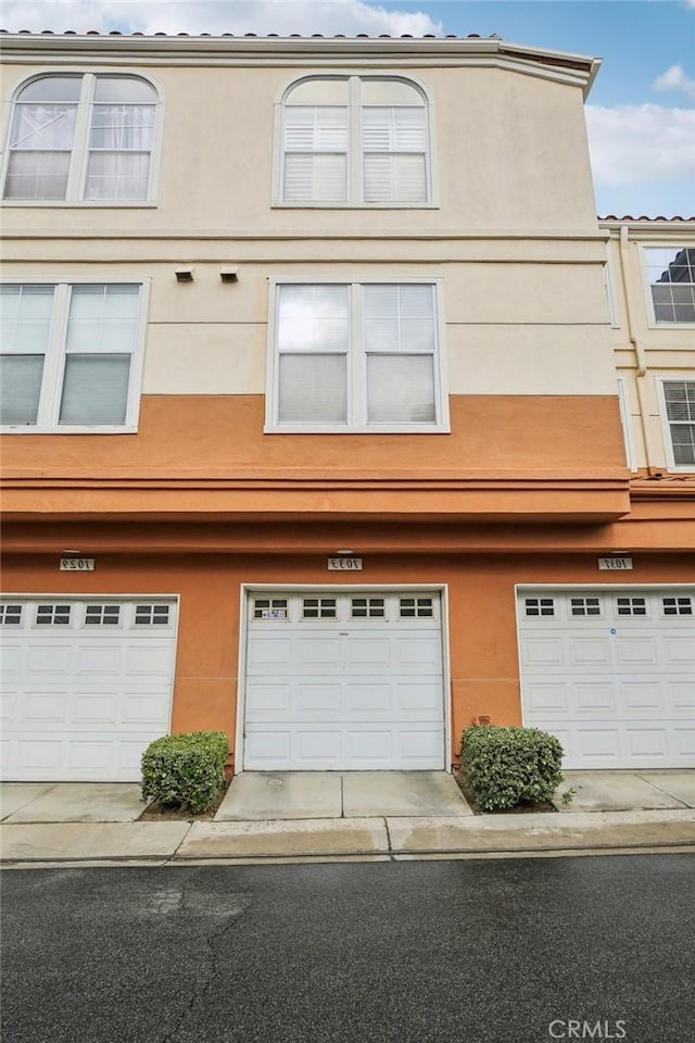 view of property featuring stucco siding and an attached garage