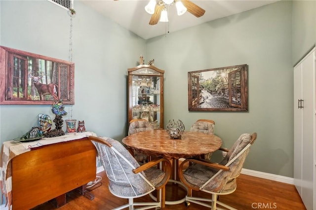 dining room with ceiling fan, baseboards, and wood finished floors