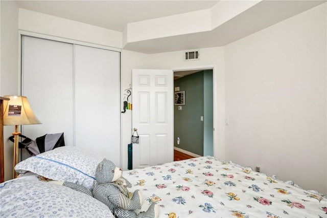 bedroom featuring a closet and visible vents