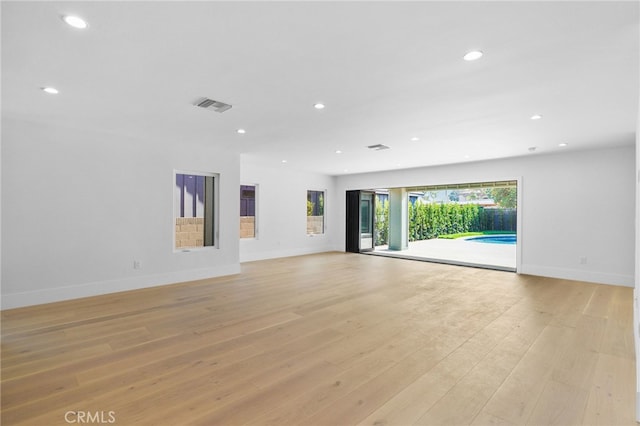 unfurnished living room with baseboards, recessed lighting, visible vents, and light wood-type flooring