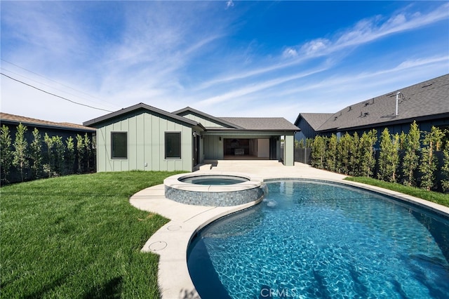 view of swimming pool featuring a patio area, a lawn, and a pool with connected hot tub