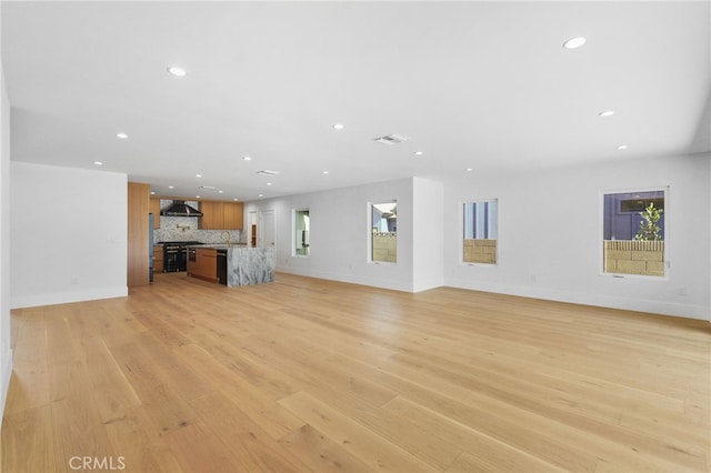 unfurnished living room featuring recessed lighting, visible vents, baseboards, and light wood-style flooring