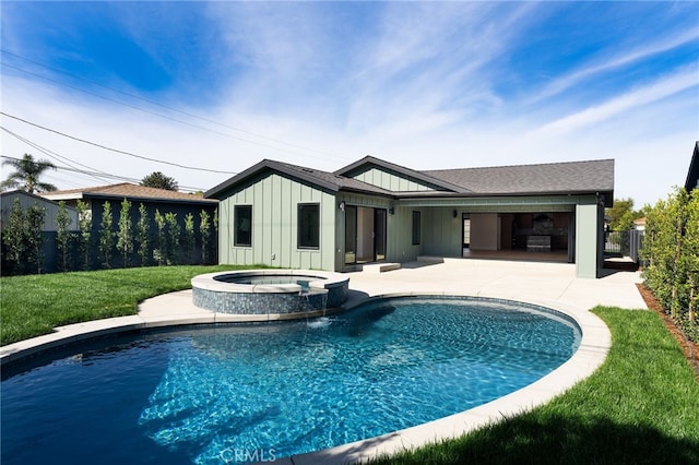 view of pool featuring a patio, a lawn, fence, and a pool with connected hot tub