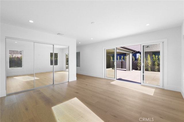 unfurnished bedroom featuring recessed lighting, visible vents, and wood finished floors