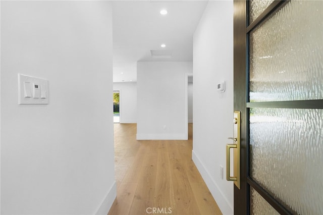 hall featuring recessed lighting, baseboards, attic access, and light wood finished floors