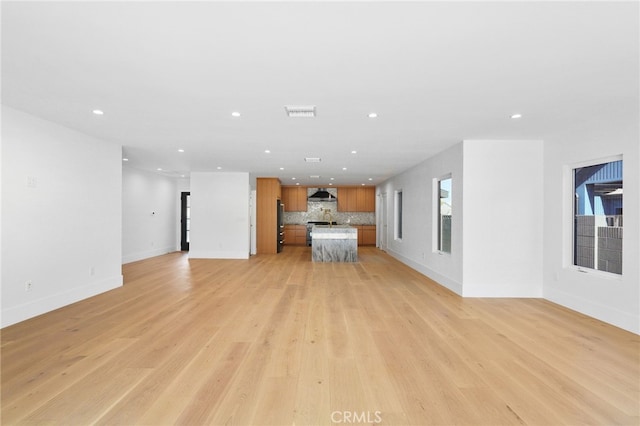 unfurnished living room with recessed lighting, visible vents, baseboards, and light wood finished floors