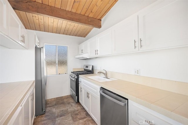 kitchen with white cabinetry, tile counters, appliances with stainless steel finishes, and a sink