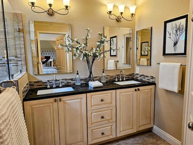 full bathroom featuring double vanity, a chandelier, and a sink