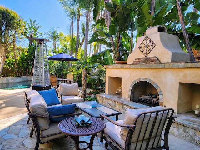 view of patio / terrace featuring an outdoor living space with a fireplace and fence