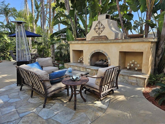 view of patio with an outdoor living space with a fireplace