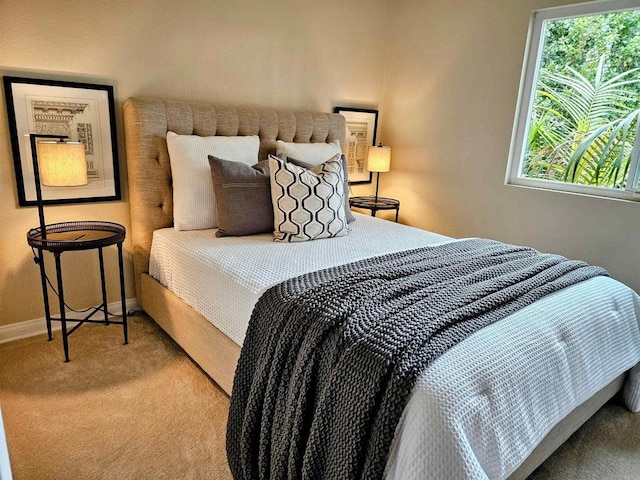 carpeted bedroom featuring baseboards