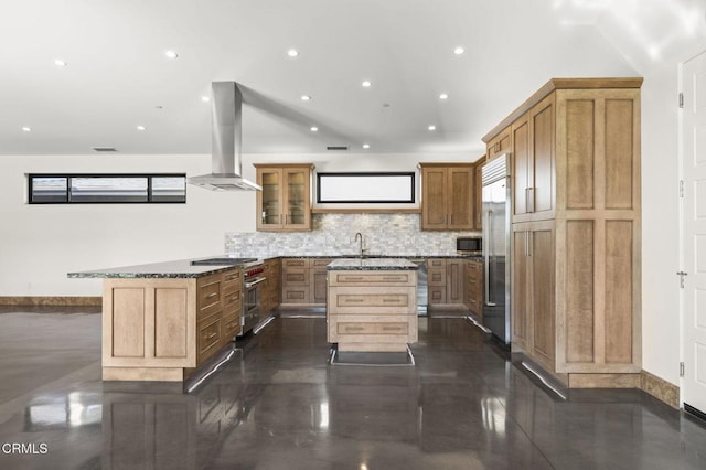 kitchen featuring high quality appliances, tasteful backsplash, a center island, a peninsula, and exhaust hood