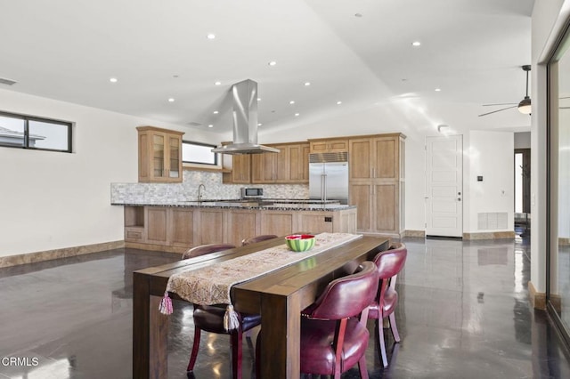kitchen featuring tasteful backsplash, a center island, vaulted ceiling, appliances with stainless steel finishes, and island exhaust hood