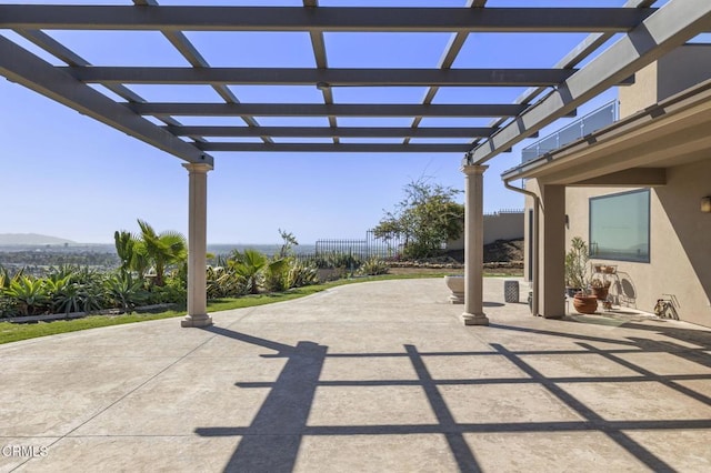 view of patio featuring a pergola and fence