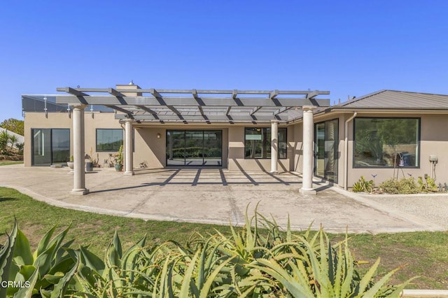 back of property with a patio area, a pergola, and stucco siding