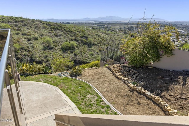 view of yard featuring fence and a mountain view