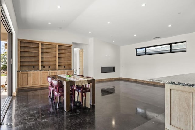 dining area with visible vents, baseboards, vaulted ceiling, recessed lighting, and a glass covered fireplace