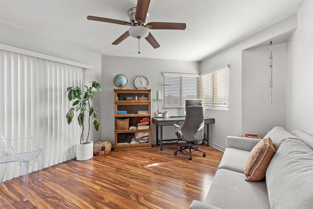 office with a ceiling fan and wood finished floors