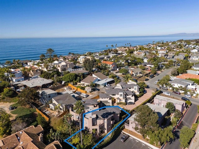 drone / aerial view with a water view and a residential view