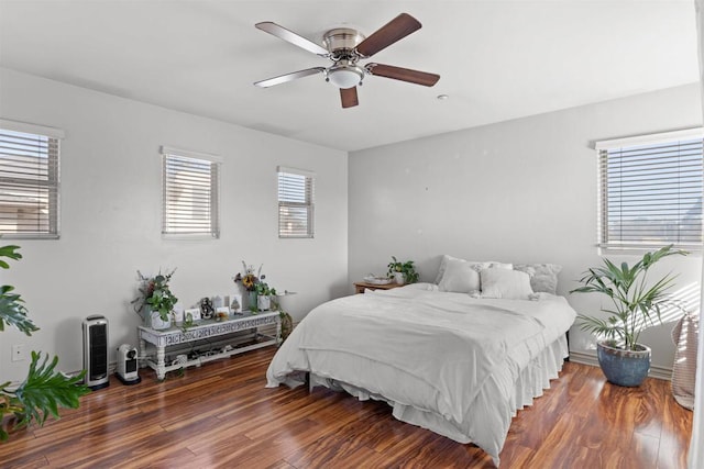 bedroom with a ceiling fan and wood finished floors