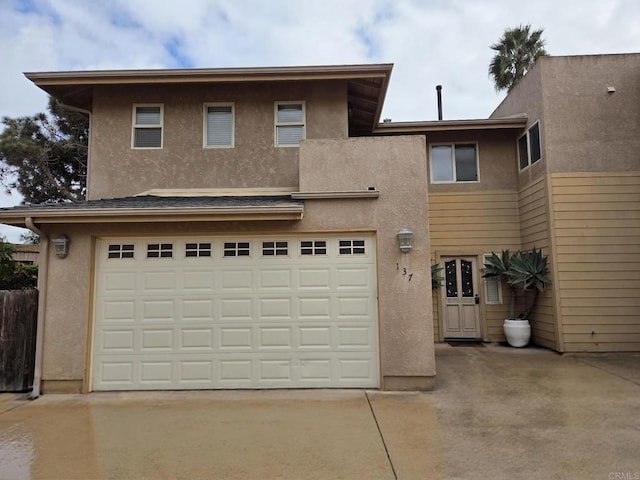 view of front of house featuring stucco siding, an attached garage, and concrete driveway