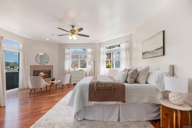 137 Jupiter St, Encinitas, CA 92024 - bedroom with multiple windows, wood finished floors, and a tiled fireplace