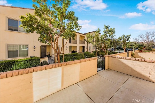 view of property's community featuring a fenced front yard and a gate