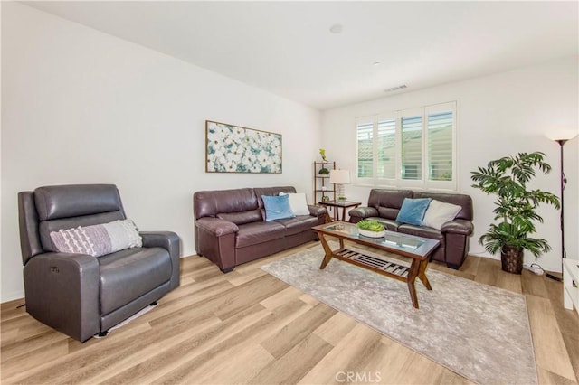 living area with visible vents and light wood-style flooring