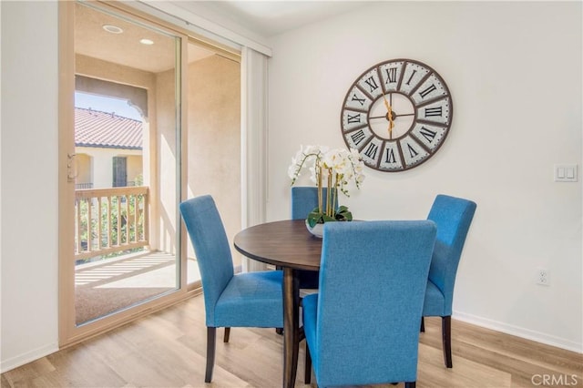 dining area featuring baseboards and wood finished floors