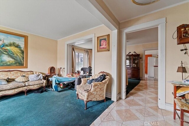 living room with baseboards, ornamental molding, and light tile patterned flooring