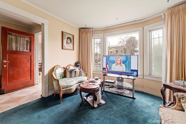 living area with light tile patterned floors, baseboards, light colored carpet, and crown molding