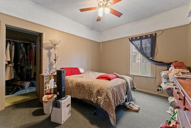 carpeted bedroom with a ceiling fan, a closet, and a textured ceiling