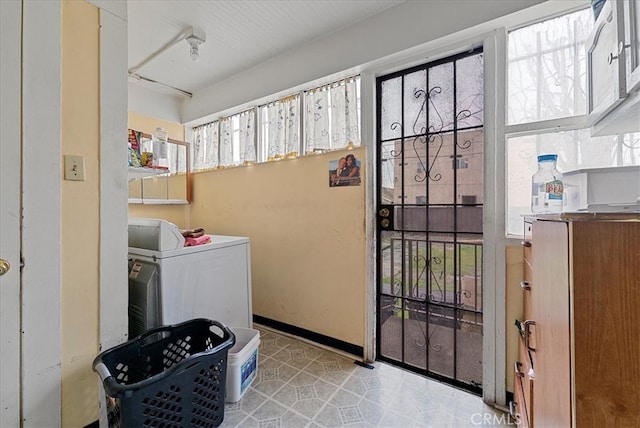 laundry area featuring washer / clothes dryer and baseboards