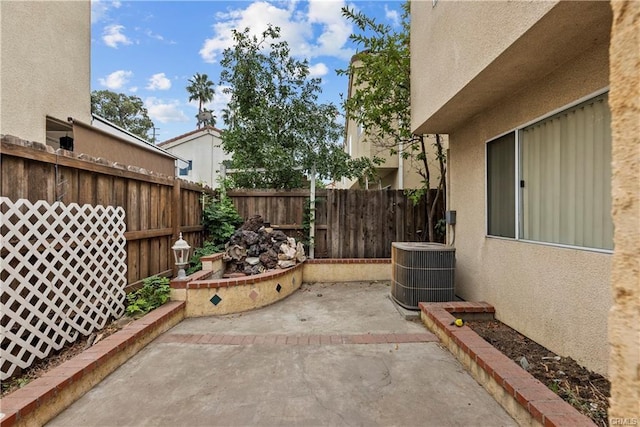 view of patio / terrace featuring central AC unit and a fenced backyard