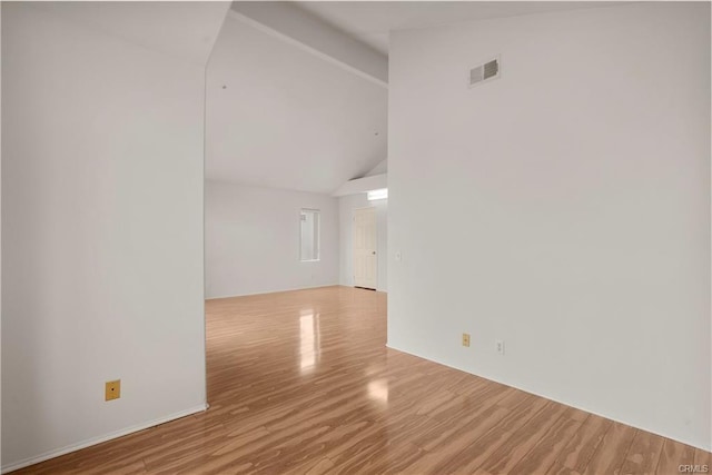 unfurnished room with visible vents, high vaulted ceiling, beamed ceiling, and wood finished floors