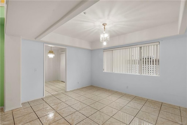 spare room featuring an inviting chandelier and light tile patterned floors