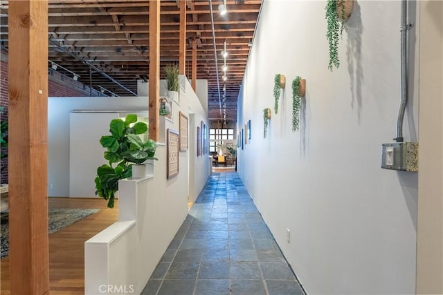 hall with stone tile floors