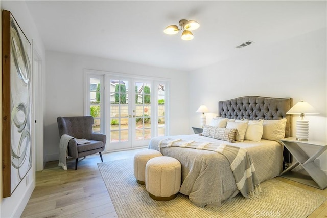 bedroom with access to outside, french doors, visible vents, and light wood-type flooring