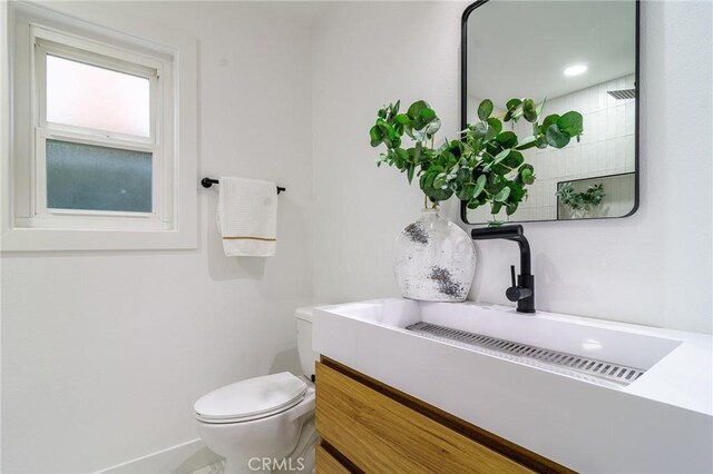 bathroom with toilet and vanity