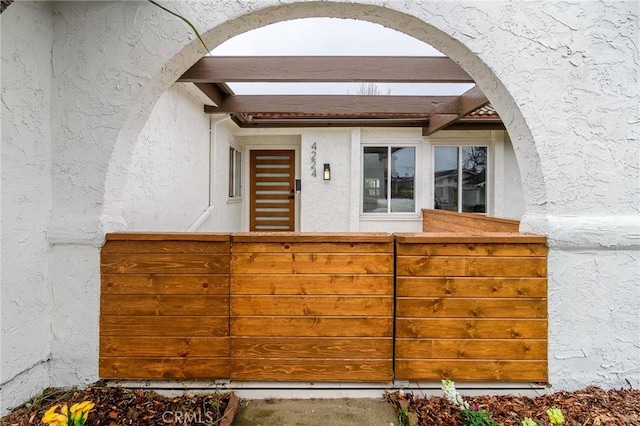 doorway to property with stucco siding