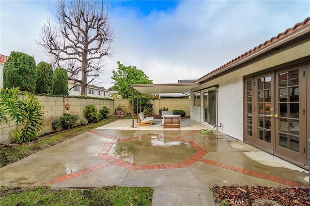 view of patio / terrace with french doors, a fenced backyard, and an outdoor hangout area