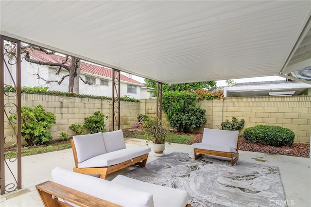 view of patio featuring an outdoor living space and a fenced backyard