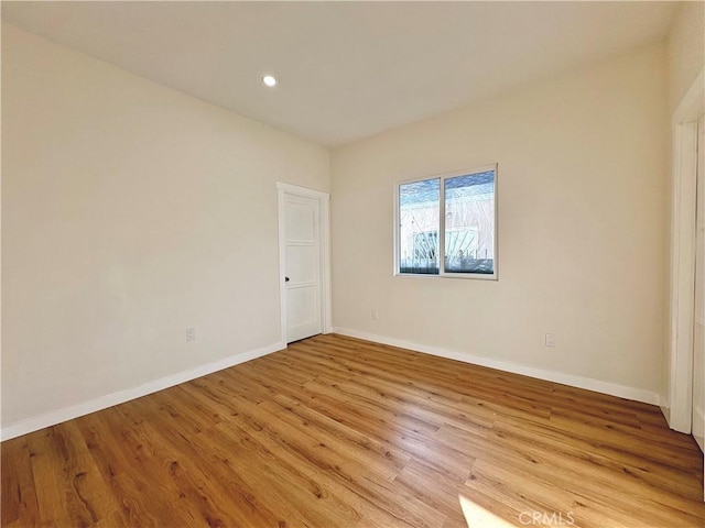 unfurnished room with recessed lighting, baseboards, and light wood-style floors