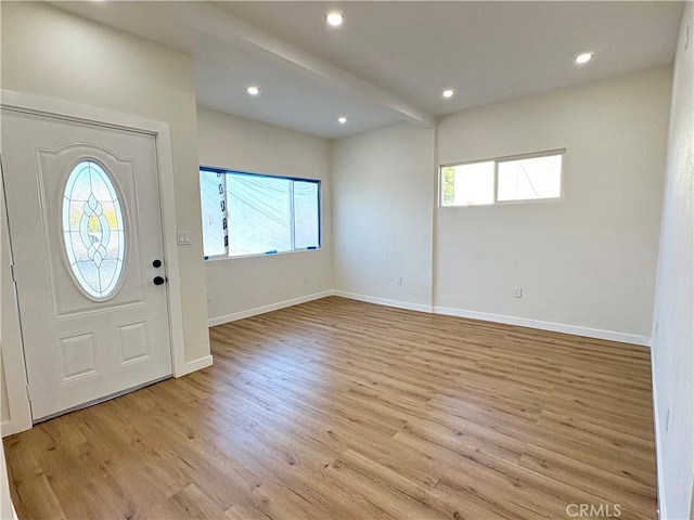 foyer featuring beam ceiling, recessed lighting, baseboards, and wood finished floors