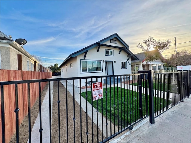 view of gate with a fenced front yard and a yard